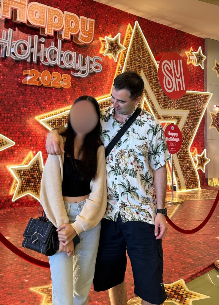 Filipina woman and her American boyfriend in SM mall in Cebu City during Christmas time.