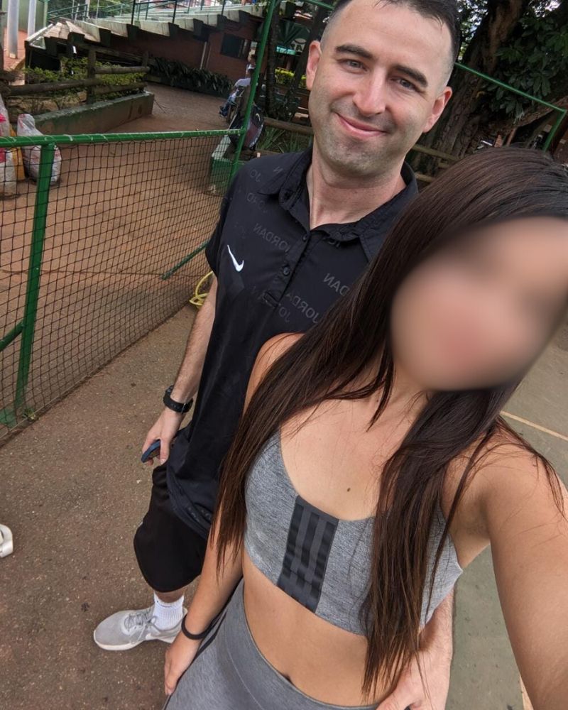 Sexy Colombian woman with her foreign American boyfriend at a park in Medellin, Colombia.