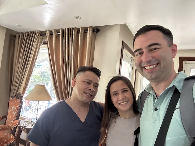 Eric James taking selfie with two friendly Filipino people at Grand Isabella Residences in Cebu City, Philippines.