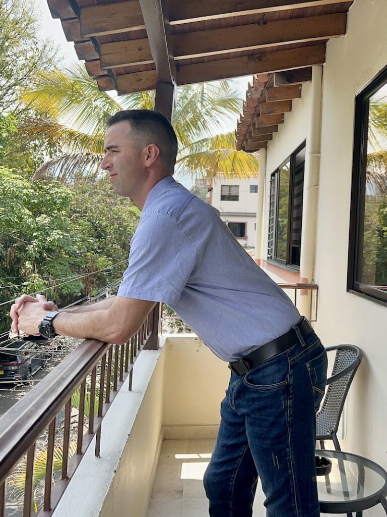 Eric James on a balcony at an apartment in Laureles, Medellin, Colombia.