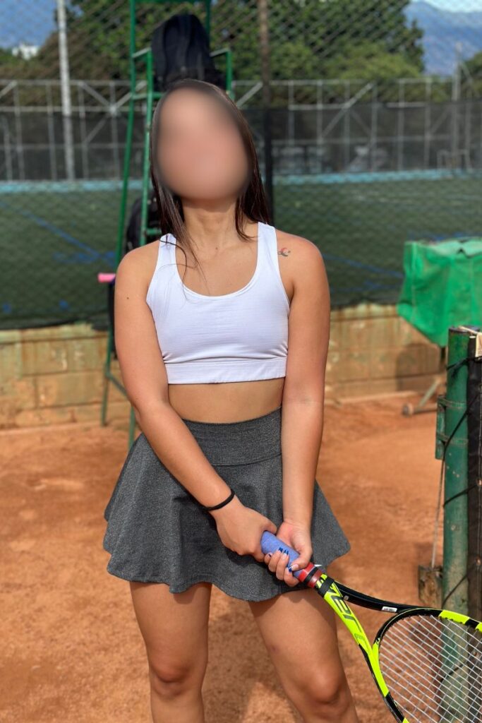 Beautiful Colombian woman taking a tennis lesson at Estadio in Medelllin, Colombia.