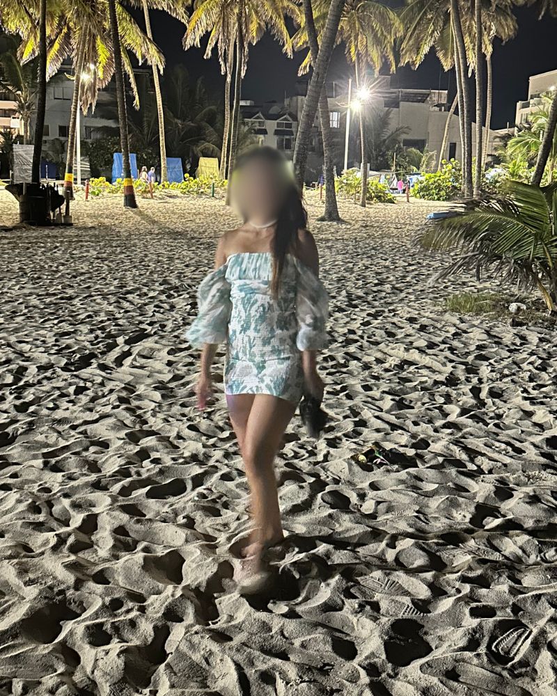 Gorgeous Colombian woman walking on the beach at night on San Andres island.