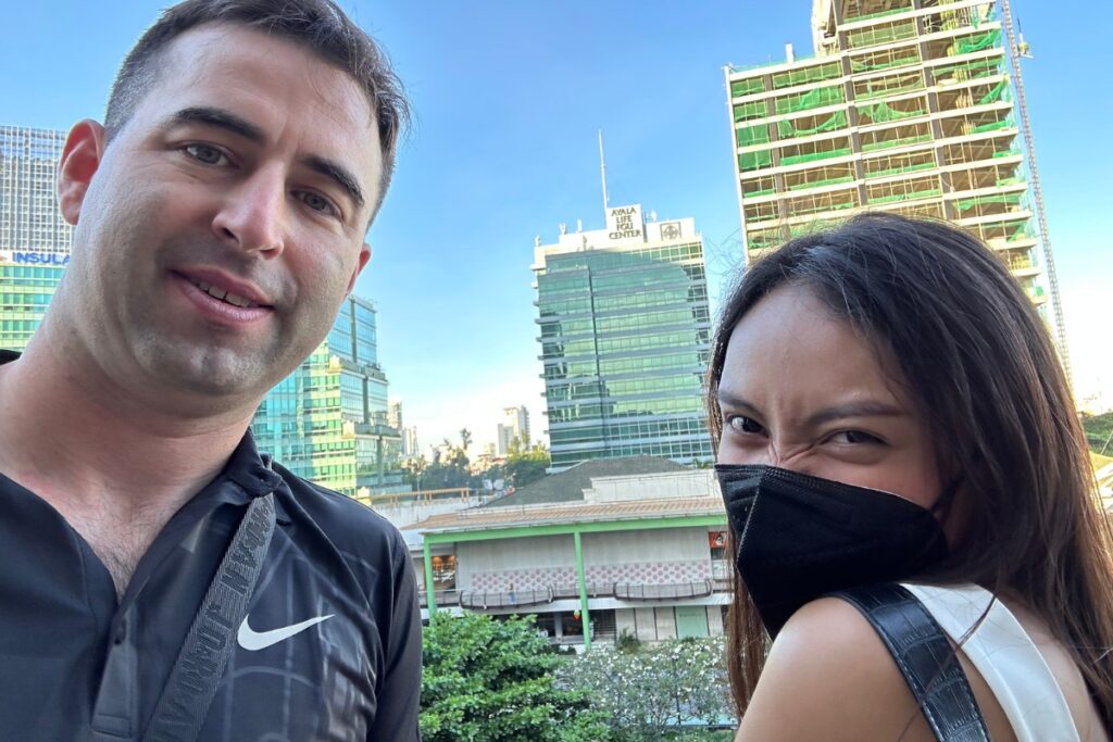 American with beautiful Filipina girlfriend wearing a mask in Cebu City, Philippines.