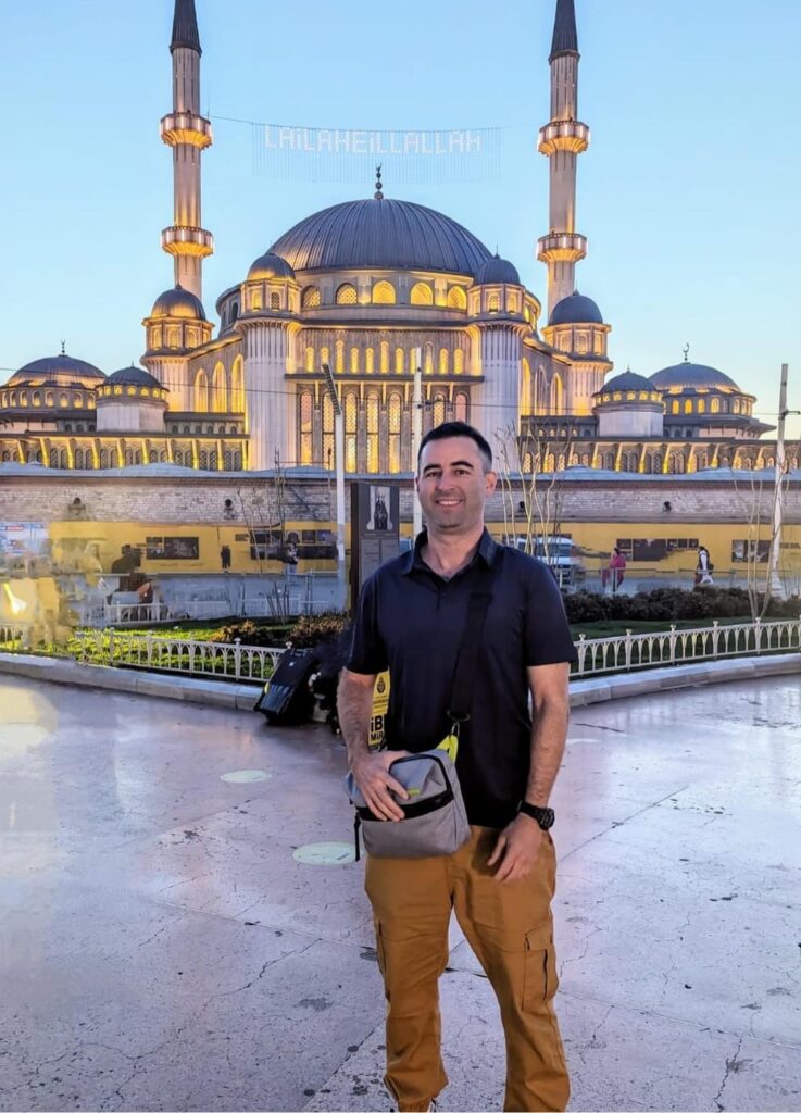 American traveler in Istanbul, Turkey in front of mosque.