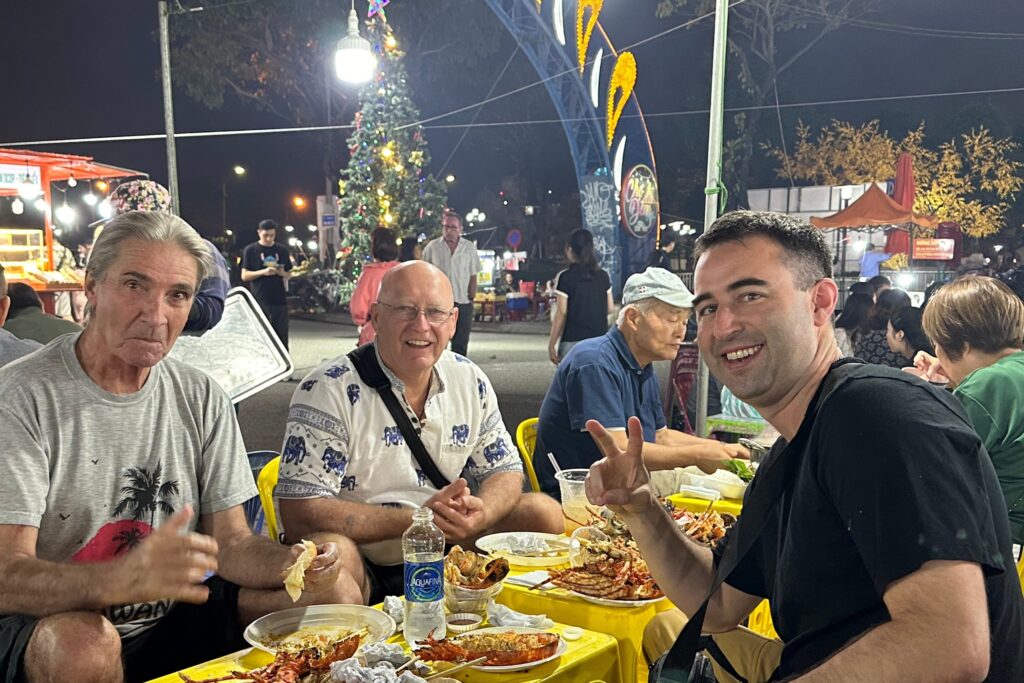 American expats hanging out in Danang, Vietnam, eating at a night market.