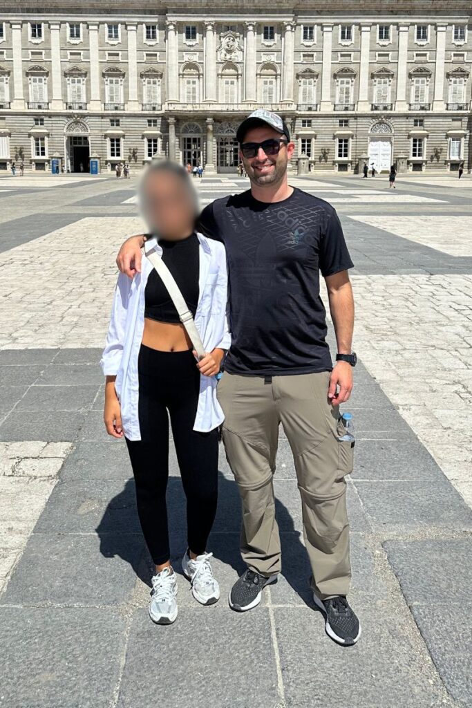 Beautiful Colombian woman with her American boyfriend on vacation visiting the Royal Palace in Madrid, Spain.