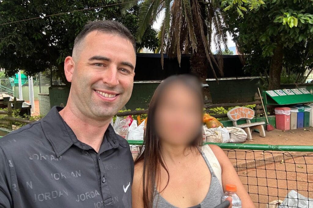 American expat (extranjero) with a beautiful Colombian girlfriend in Medellin, Colombia at Estadio station.