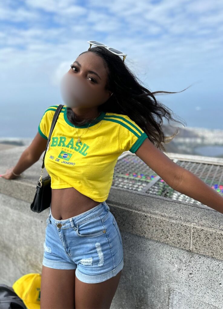 Smoking hot Brazilian model visiting the Christ the Redeemer statue in Rio de Janeiro. 