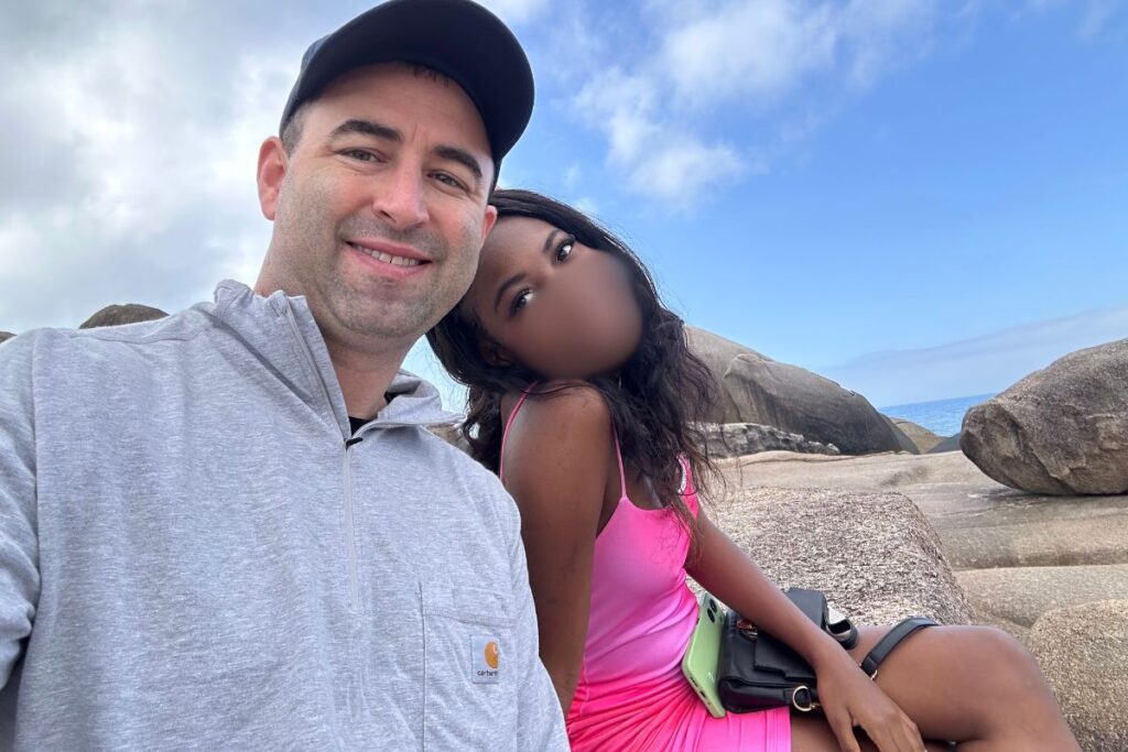 Beautiful black Brazilian girlfriend with her white American boyfriend on the beach in Florianopolis, Brazil.