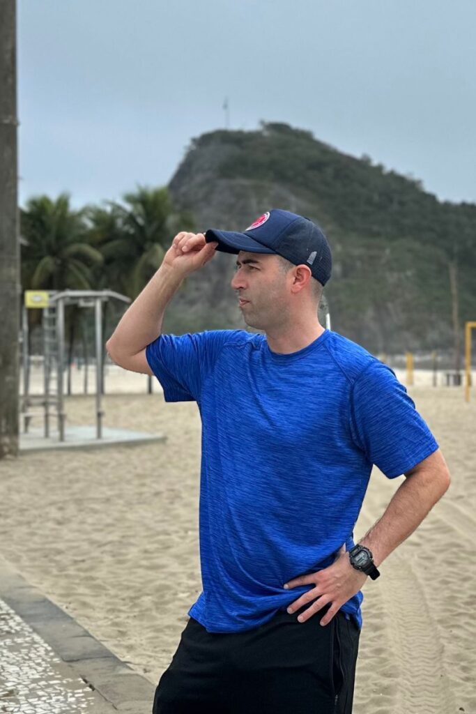 Eric James standing at on Copacabana beach in Rio de Janeiro, Brazil.