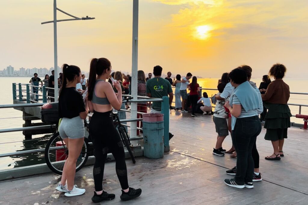 Florianopolis pier salsa dancing with sunset in the background and beautiful women.