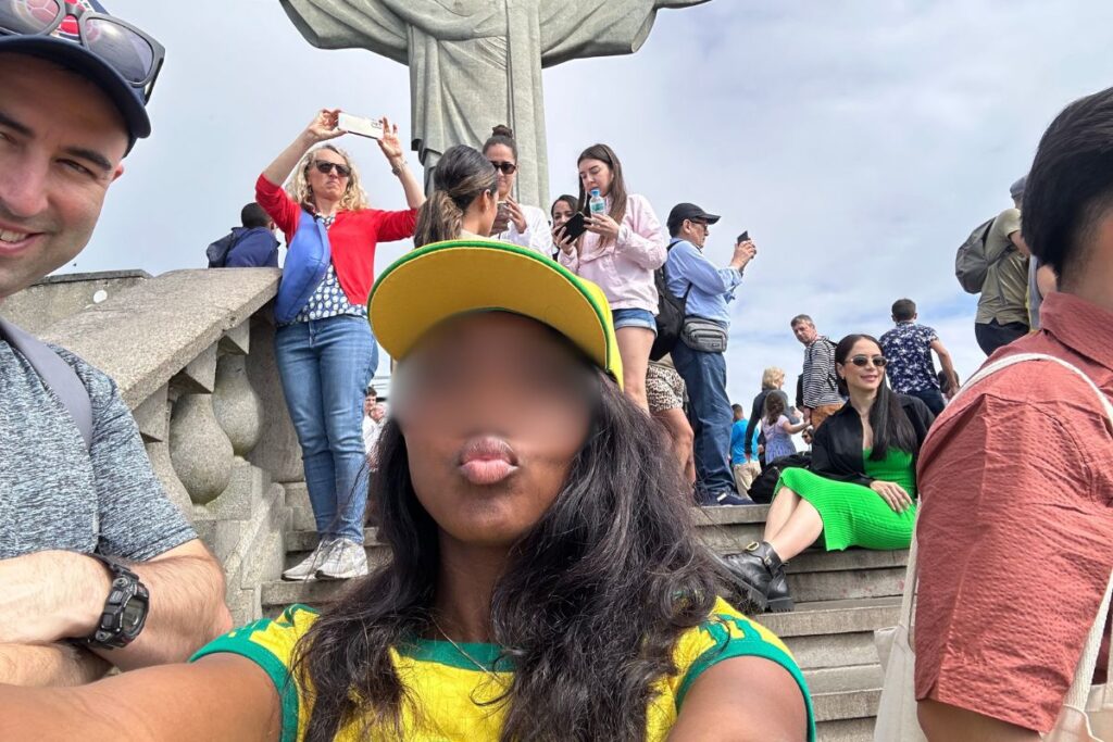 Beautiful Brazilian woman with her expat boyfriend visiting the Christ the Redeemer statue.