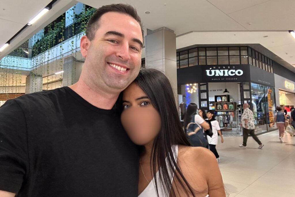 American boyfriend with sexy Colombian girlfriend in a shopping mall in Medellin, Colombia.