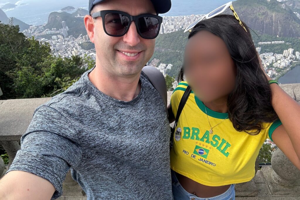 American man with gorgeous black Brazilian woman in Rio de Janeiro, statue of Christ the Redeemer.